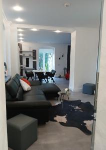 a living room with a couch and a table at Ferienwohnung im alten Forstamt in Erndtebrück
