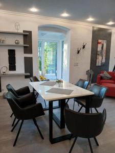 a dining room with a table and chairs at Ferienwohnung im alten Forstamt in Erndtebrück +9 photos