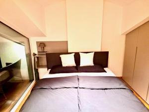 a bedroom with a large bed in a room at Apartments C'EST LA SEA - Whirlpool-Suite oder Dachterrassen-Suite in Neusiedl am See +59 photos