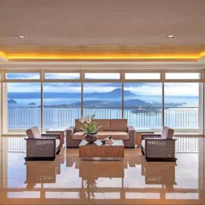 a living room with a couch and chairs and a table at Casa Angelica in Tagaytay
