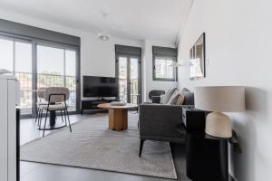 a living room with a couch and a table at Blueground Florentine, City view in Tel Aviv