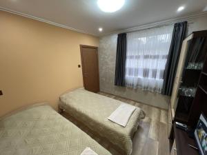 a small room with two beds and a window at Edelvais1 Еделвайс1 in Chukovezer +7 photos