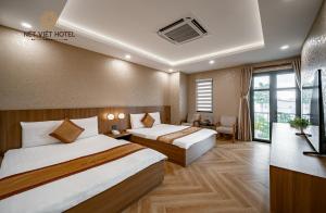 Postel nebo postele na pokoji v ubytování Nét Việt Hotel Vincom Sóc Trăng