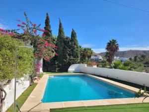 a swimming pool in the backyard of a house at Casa La Cúpula in Agua Amarga