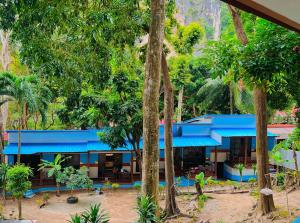 a blue house with trees in front of it at Mom Boutique Railay in Railay Beach