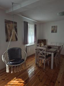 a living room with a swing chair and a table at Holiday Home Ciara in Kolašin