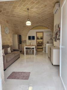 a living room with a couch and a table at Rossè B&B Holiday House in Trani