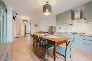 eine Küche und ein Esszimmer mit einem Holztisch und Stühlen in der Unterkunft Novalesi Vintage interno 2 in Noale