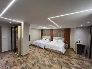 a hotel room with two beds and a room with two mirrors at Pyramids Enigma Grand Lodge in Cairo +56 photos
