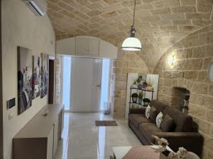 a living room with a couch and a table at Rossè B&B Holiday House in Trani