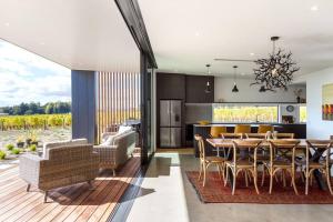 a kitchen and dining room with a table and chairs at 89 In The Vines in Martinborough