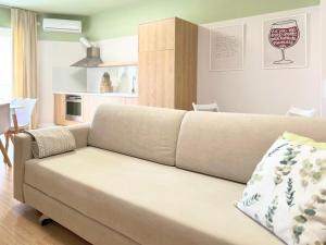 a living room with a couch and a kitchen at Cozy Nest Golem in Golem