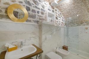 a bathroom with a sink and a toilet and a shower at HANI I PAZARIT Boutique Hotel in Korçë +69 photos
