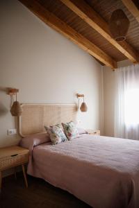a bedroom with a bed with two pillows on it at El gallinero de la abuela Claudia in Aldea de Trujillo