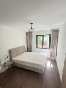 a bedroom with a large bed and a window at Maslina- 3 bedroom apartment in Kotor