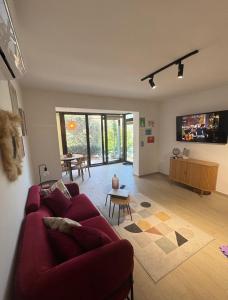 a living room with a red couch and a table at Maslina- 3 bedroom apartment in Kotor