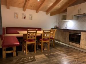 a kitchen with a wooden table and chairs at Ferienhaus Philipp Rofner in Leogang