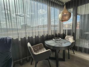 a dining room with a table and chairs and a window at Suites im Cloud in Stuttgart