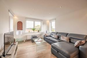 a living room with a couch and a table at 3Bed, 2Bath Penthouse Near Windsor & Long Walk in Windsor