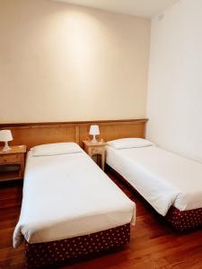 Postel nebo postele na pokoji v ubytování Gorizia Inn
