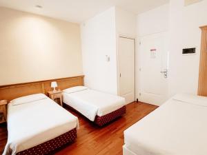 Postel nebo postele na pokoji v ubytování Gorizia Inn