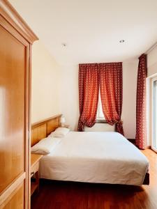 Postel nebo postele na pokoji v ubytování Gorizia Inn
