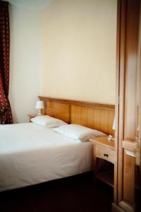 Postel nebo postele na pokoji v ubytování Gorizia Inn
