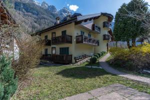 a house in the mountains with a yard at Dolomites Soundscape - Birds River Snow Ski Bus Bike Hike in Alleghe +15 photos
