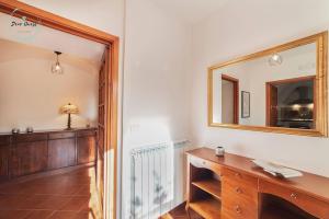 a bathroom with a mirror and a wooden dresser at Ca du Muccin in Calice Ligure +45 photos