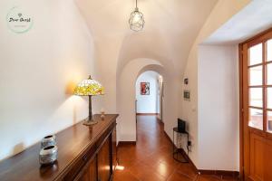 a living room with a table with a lamp on it at Ca du Muccin in Calice Ligure