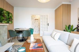 a living room with a couch and a table at Tropical Escape near city center Fiber Netflix in Montluçon +29 photos