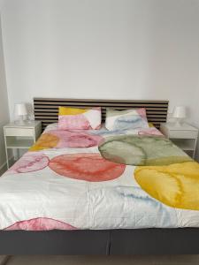 a bed with colorful blankets and pillows on it at Casa Diana Golf in Murcia +67 photos