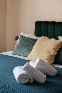 a towel sitting on top of a bed with pillows at La Maison d'en Bas des Seigneurs in Cucuron +19 photos