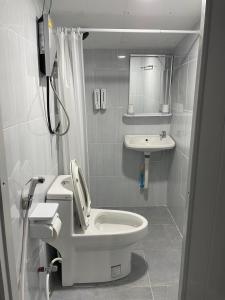 a white bathroom with a toilet and a sink at No5 Hostel Songkhla in Songkhla +66 photos