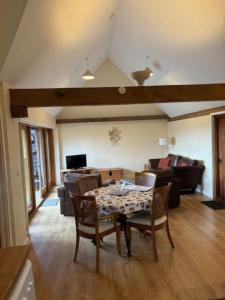 a living room with a table and a couch at 3 Coopers Cottages, Bodiam, East Sussex in Bodiam