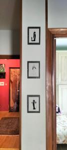 a room with three pictures on a white wall at La Casita b&b in Bagnoregio