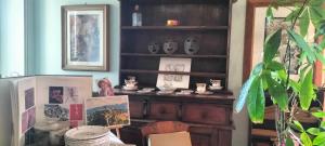 a room with a wooden book shelf with pictures on it at La Casita b&b in Bagnoregio