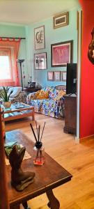a living room with a bed and a table at La Casita b&b in Bagnoregio