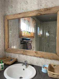 a bathroom with a sink and a mirror at Tulia Room in Dar es Salaam
