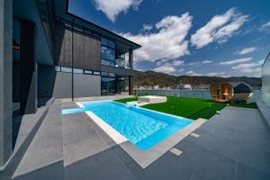 an external view of a house with a swimming pool at CYAN 思庵 旧ELSUENITOhinase in Hinase