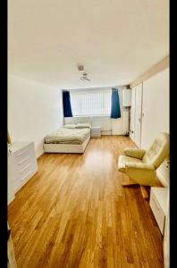 a bedroom with a bed and a chair in a room at Wigston Homestay in Wigston Magna