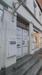 un edificio con dos puertas blancas a un lado. en Wohnung Schlossblick, en Celle