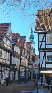 una calle de la ciudad con edificios y una torre del reloj en Wohnung Schlossblick, en Celle