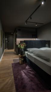 a bedroom with a large bed with a plant on it at Leipzig Suites in Leipzig