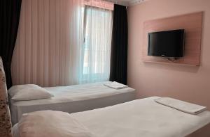 Postel nebo postele na pokoji v ubytování Ottoman Hotel Sakarya