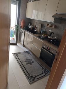 a kitchen with stainless steel appliances and a rug at Appartement de vacances in Agadir +2 photos