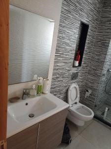 a bathroom with a sink and a toilet at Appartement de vacances in Agadir