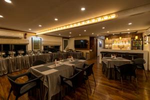 a restaurant with tables and chairs and a bar at Vikash Eco Resort in Bālugān