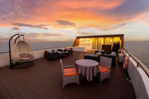 a balcony on a cruise ship with a table and chairs at Vikash Eco Resort in Bālugān