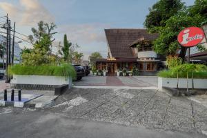 a coca cola sign in front of a building at Indraloka Heritage Homestay in Yogyakarta